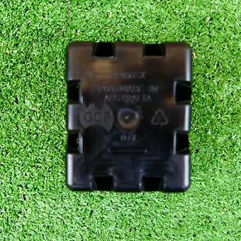 Bottom view of a black square plastic plant pot showing drainage openings.